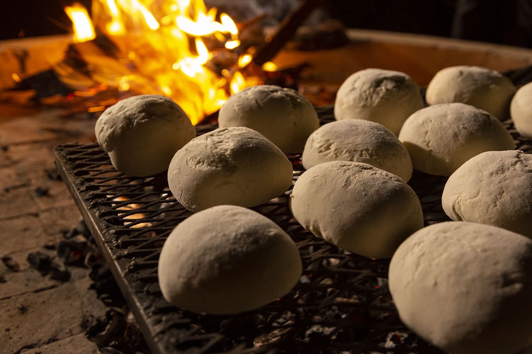 Bread rolls baking on the grill over the fire